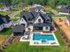 Aerial view of the home, pool, and outdoor living spaces shows the expanse of the property at 406 Sugar Maple Ln, Weddington, NC 28104
