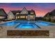 Gorgeous backyard with a pool, hot tub, and outdoor furniture, perfect for entertaining and relaxation at 406 Sugar Maple Ln, Weddington, NC 28104