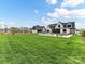Expansive backyard showcasing a well-maintained lawn, large pool area, and inviting outdoor seating at 406 Sugar Maple Ln, Weddington, NC 28104