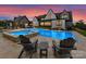 Expansive backyard featuring a luxurious pool, a spa, elegant furniture, and a well-maintained lawn at 406 Sugar Maple Ln, Weddington, NC 28104