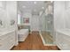 Luxury bathroom with double vanity, soaking tub and seamless glass shower with built-in bench at 406 Sugar Maple Ln, Weddington, NC 28104