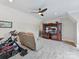 Bright bonus room features plush carpet, a ceiling fan, home gym equipment, a large TV, and relaxed seating for many activities at 406 Sugar Maple Ln, Weddington, NC 28104