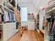 Large walk-in closet with custom shelving, storage and a wooden ladder at 406 Sugar Maple Ln, Weddington, NC 28104