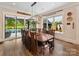 Bright dining room boasts stylish lighting, large table with backyard pool view and access at 406 Sugar Maple Ln, Weddington, NC 28104