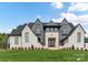 Stunning two-story home featuring a light-colored brick facade, gabled roof, and expansive front lawn at 406 Sugar Maple Ln, Weddington, NC 28104
