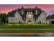 Stunning modern farmhouse with a manicured lawn, stylish black-and-white color scheme, and elegant front entrance at 406 Sugar Maple Ln, Weddington, NC 28104