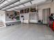 This spacious garage features epoxy flooring, custom storage cabinets, and slat wall organization system at 406 Sugar Maple Ln, Weddington, NC 28104