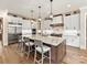 Modern kitchen with stainless steel appliances, granite countertops, and an island with bar seating at 406 Sugar Maple Ln, Weddington, NC 28104