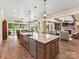 Spacious kitchen island with granite countertops and wood cabinets at 406 Sugar Maple Ln, Weddington, NC 28104