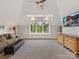 Bright living room includes carpet, a ceiling fan, a wide window with tree views, couch, tv and a wooden dresser at 406 Sugar Maple Ln, Weddington, NC 28104