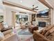 Comfortable living room with stone fireplace, wood beams, and abundant seating at 406 Sugar Maple Ln, Weddington, NC 28104