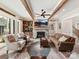 Cozy living room featuring a stone fireplace, wood beams, and hardwood floors at 406 Sugar Maple Ln, Weddington, NC 28104