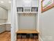 A functional mudroom provides storage with gray cabinets, drawers, and wood bench at 406 Sugar Maple Ln, Weddington, NC 28104