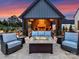 Relaxing covered patio with a stone fireplace and cozy seating area, perfect for outdoor entertaining at 406 Sugar Maple Ln, Weddington, NC 28104