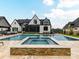 Beautiful pool and spa with stone accents, perfect for relaxation and entertainment at 406 Sugar Maple Ln, Weddington, NC 28104