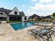 Relaxing poolside view with sun loungers, a large pool, and a detached patio with outdoor dining at 406 Sugar Maple Ln, Weddington, NC 28104