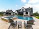 Inviting backyard showcasing a pool, spa, and outdoor seating area for ultimate relaxation at 406 Sugar Maple Ln, Weddington, NC 28104