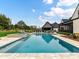 Stunning in-ground pool with a spa, surrounded by a well-manicured lawn and inviting backyard at 406 Sugar Maple Ln, Weddington, NC 28104