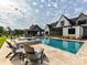 Expansive pool area with lounge chairs, a spa, and a covered patio perfect for outdoor entertaining at 406 Sugar Maple Ln, Weddington, NC 28104