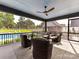 Inviting covered porch with comfortable seating, a ceiling fan, and a view of the backyard pool at 406 Sugar Maple Ln, Weddington, NC 28104