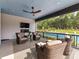 Inviting covered porch with comfortable seating, a fireplace, and a view of the backyard pool at 406 Sugar Maple Ln, Weddington, NC 28104
