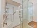 Close up of a luxurious glass shower with a built-in bench and upscale fixtures at 406 Sugar Maple Ln, Weddington, NC 28104