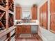 Custom wine cellar with wooden racks and sink at 406 Sugar Maple Ln, Weddington, NC 28104