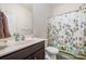 Bright bathroom with a vanity, toilet, and shower with a decorative shower curtain at 428 Wheat Field Dr, Mount Holly, NC 28120