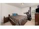 Bedroom with a comfortable bed, a modern treadmill and a wooden dresser with mounted TV at 428 Wheat Field Dr, Mount Holly, NC 28120
