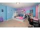 Colorful ' bedroom featuring a bunk bed and a desk near the window at 428 Wheat Field Dr, Mount Holly, NC 28120