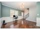 Bright dining room with hardwood floors, white wainscoting and natural light, perfect for Gathering gatherings at 428 Wheat Field Dr, Mount Holly, NC 28120