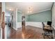 Elegant dining room with rich hardwood floors, classic wainscoting, and a stylish chandelier at 428 Wheat Field Dr, Mount Holly, NC 28120