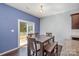 Cozy dining area with dark wood table, bench, and sliding glass doors to the backyard at 428 Wheat Field Dr, Mount Holly, NC 28120