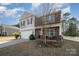 Inviting two-story home with stone accents, a cozy front porch, and well-kept landscaping in a suburban setting at 428 Wheat Field Dr, Mount Holly, NC 28120