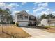 Well-manicured two-story home with a two-car garage and a neatly landscaped front yard under a bright sky at 428 Wheat Field Dr, Mount Holly, NC 28120