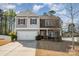 Attractive two-story home with stone and siding accents, complemented by a driveway and manicured front lawn at 428 Wheat Field Dr, Mount Holly, NC 28120
