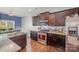Spacious kitchen featuring granite countertops, stainless steel appliances, and an adjacent dining area at 428 Wheat Field Dr, Mount Holly, NC 28120