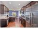 Bright kitchen with stainless steel appliances, granite countertops, and adjoining dining space at 428 Wheat Field Dr, Mount Holly, NC 28120