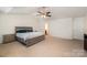 Large main bedroom with a tray ceiling, a king bed, and access to an ensuite bathroom at 428 Wheat Field Dr, Mount Holly, NC 28120