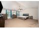 Spacious main bedroom featuring ample natural light, a ceiling fan, and an ensuite bathroom at 428 Wheat Field Dr, Mount Holly, NC 28120