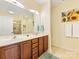 Bathroom featuring double sinks, decorative artwork, and a glass-enclosed shower at 4434 Patriots Hill Rd, Mint Hill, NC 28227