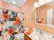 Charming peach bathroom with floral shower curtain at 4434 Patriots Hill Rd, Mint Hill, NC 28227