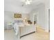 Light-filled bedroom features a white bed frame and furniture and neutral walls at 4434 Patriots Hill Rd, Mint Hill, NC 28227
