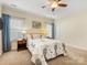 Inviting bedroom with ceiling fan, carpeted floor, and coordinated nightstands with lamps at 4434 Patriots Hill Rd, Mint Hill, NC 28227