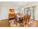 Dining room featuring wood table with seating for eight, hardwood floor, and chandelier lighting at 4434 Patriots Hill Rd, Mint Hill, NC 28227