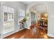 Bright entryway with hardwood floor and archway leading to dining room and kitchen at 4434 Patriots Hill Rd, Mint Hill, NC 28227