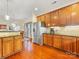 Bright kitchen with wooden cabinets, stainless steel refrigerator, and hardwood floors at 4434 Patriots Hill Rd, Mint Hill, NC 28227
