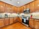 Well-lit kitchen featuring wood cabinets, granite countertops, and stainless steel appliances at 4434 Patriots Hill Rd, Mint Hill, NC 28227