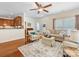 Open living room with hardwood floors, area rug, view to kitchen, and access to other rooms at 4434 Patriots Hill Rd, Mint Hill, NC 28227