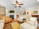 Inviting living room with fireplace, ceiling fan, and view to dining area and kitchen at 4434 Patriots Hill Rd, Mint Hill, NC 28227